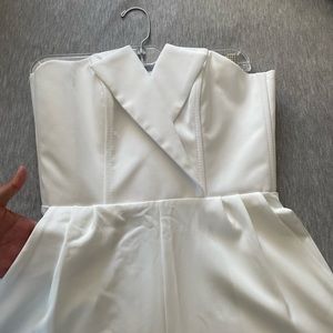 White strapless jumpsuit with pockets and asymmetrical neckline